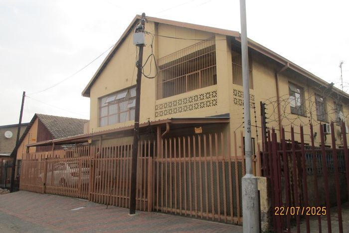 For Sale: Spacious 12-bedroom house in Actonville with security, garage, and outdoor space.