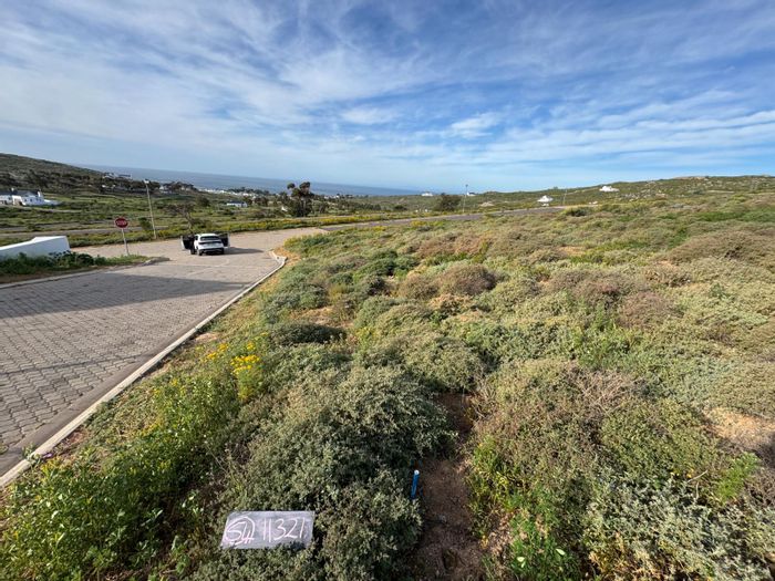 Vacant Land for Sale at St Helena Views with Scenic Sea and Rocky Backdrop.