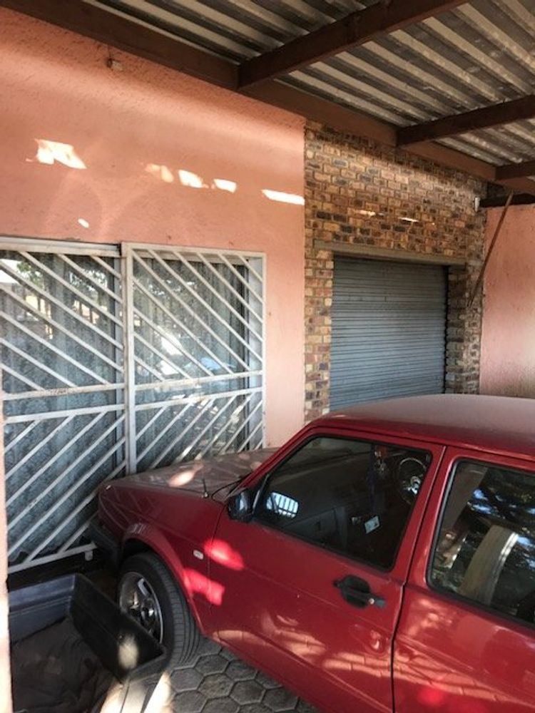 Single garage with entrance and double carport