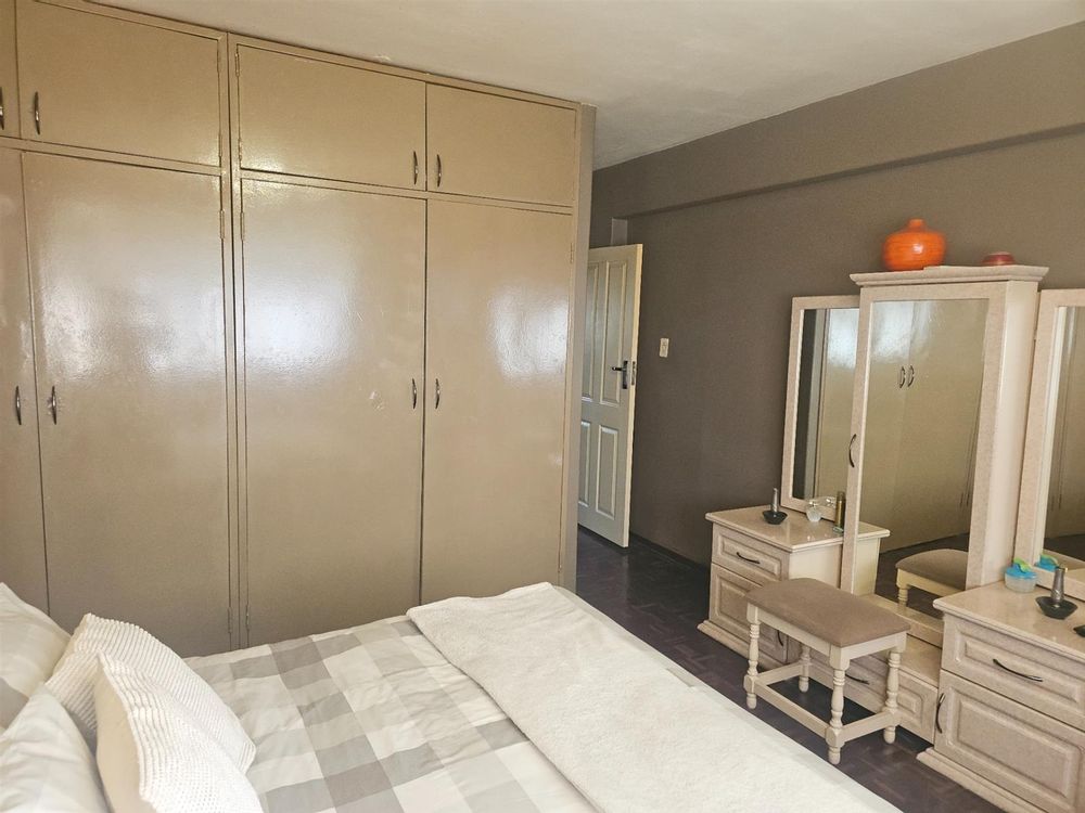 Built in cupboards in beautifully manicured bedroo