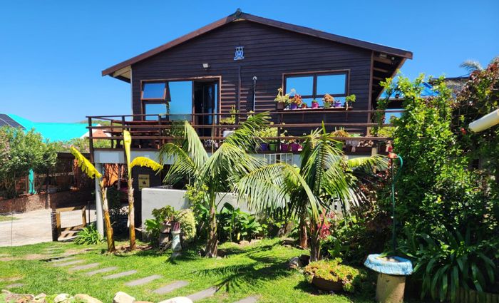 Coastal house for sale in Paradise Beach with income-generating flats and beach access.