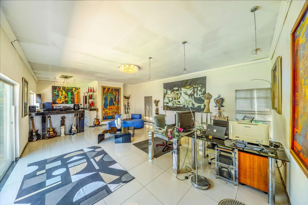 Living room with bar, fireplace and office area