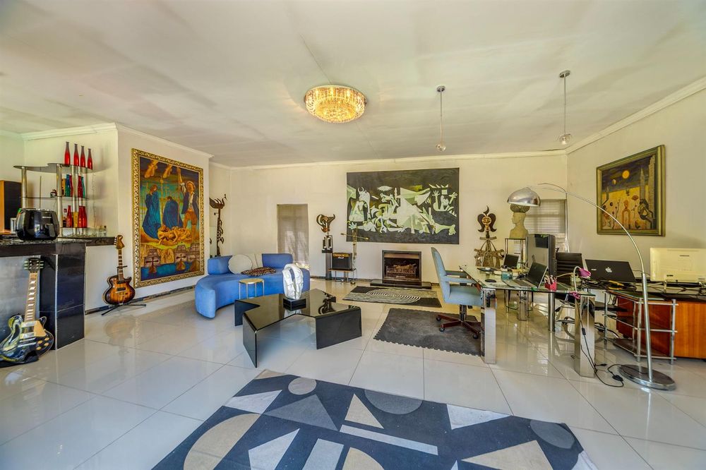 Living room with bar, fireplace and office area