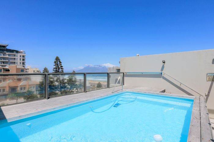 Coastal Apartment for Sale in Table View: Balcony, Pool, Secure Parking, Near Beach.