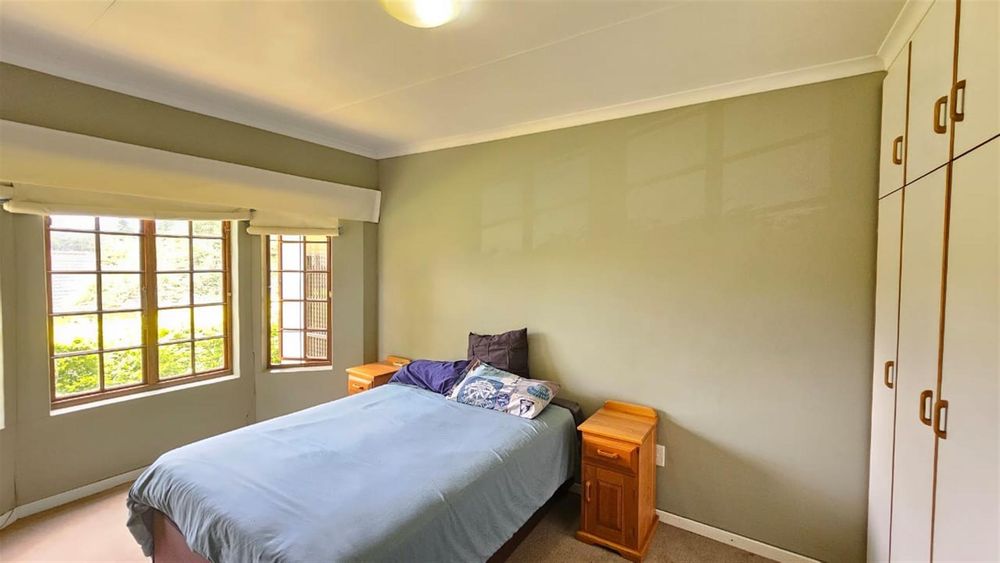 airy bedroom with bay windows
