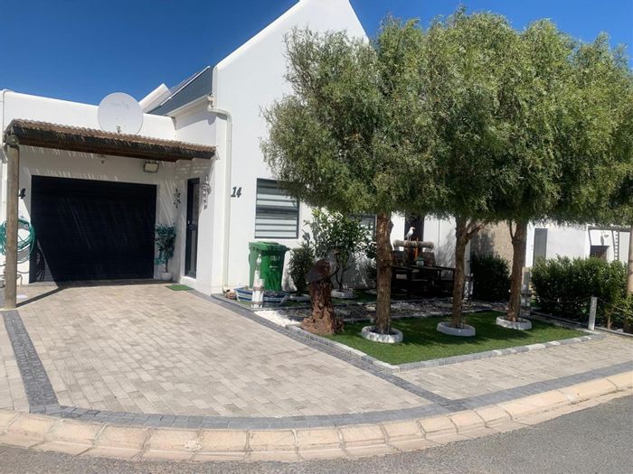 House For Sale in Jacobsbaai: Open-plan living, braai area, secure estate, solar power.