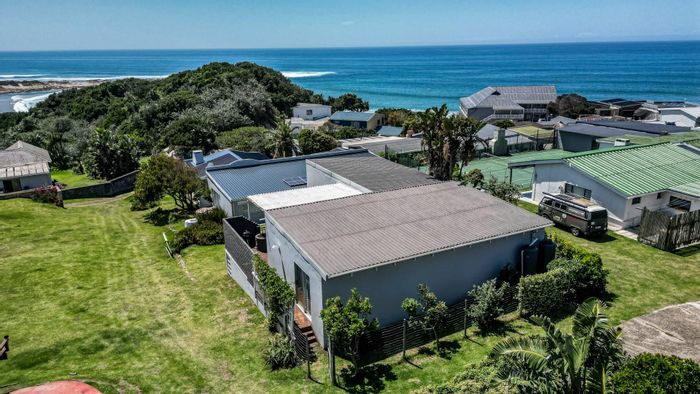 Coastal house in Glengariff for sale: ocean views, deck, bar, outdoor shower.