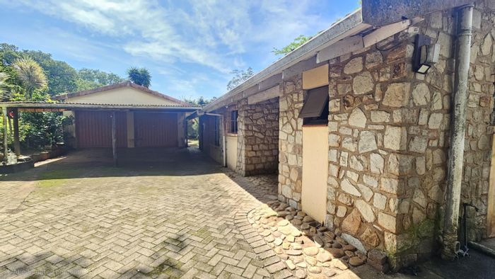 Charming Uvongo house for sale with garden, sunroom, and garage space.