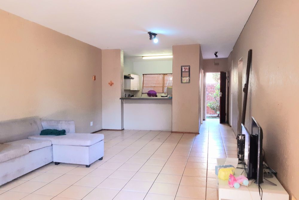 Lounge looking onto kitchen and front door