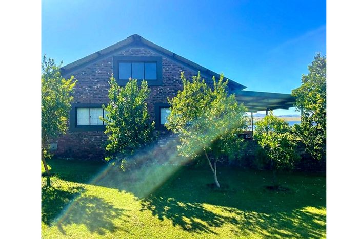 For Sale: House in Badplaas Central with waterfront access, solar power, and spacious patio.