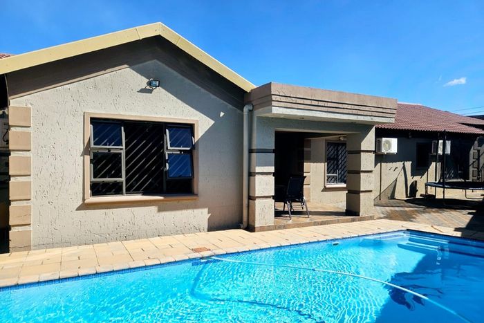 For Sale: Spacious 4-bedroom house in Lenasia South with pool and double garages.
