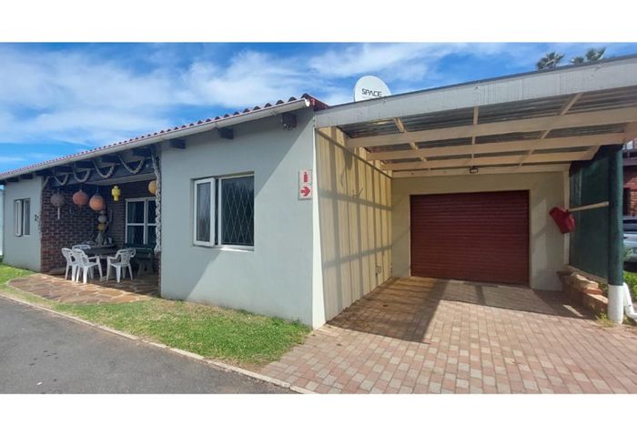 Coastal house for sale in Queensberry Bay with courtyard, garage, and community amenities.