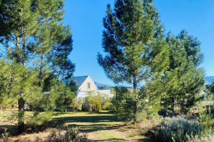 Tesselaarsdal Farm For Sale: Two homes, off-grid living, income potential, scenic views.