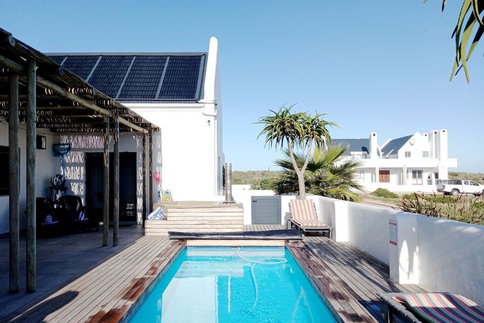 For Sale: 4-bedroom house in Jacobsbaai with pool, guest suite, and ocean views.