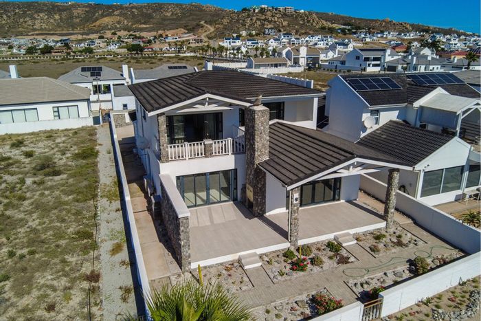 Beachfront house in Sandy Point for sale, featuring ocean views and spacious living.