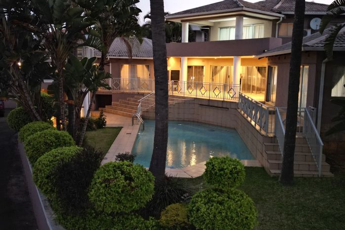 For Sale: 4-bedroom house in Umhlanga Central with pool, garden, and garage.
