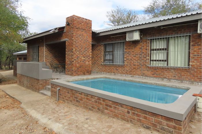 House For Sale in Marloth Park Central: 4 beds, pool, guest suite, spacious outdoor area.