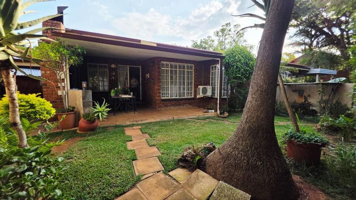 Townhouse To Rent in Wonderboom: Open-plan living, study area, private courtyard, garage.