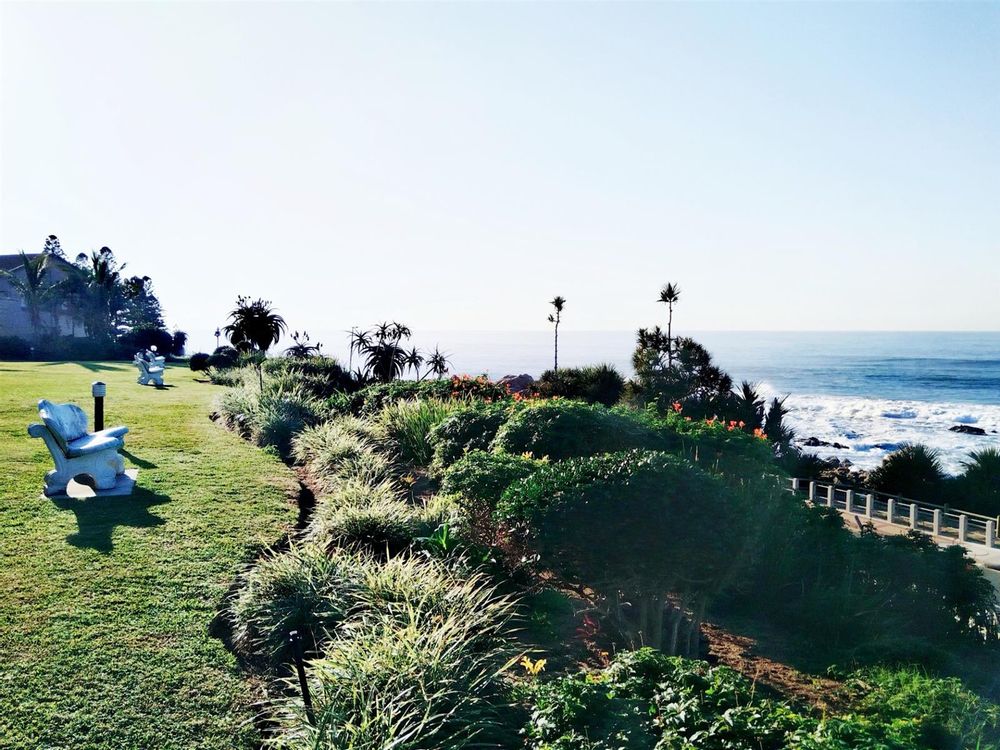 Seating spaces in garden overlooking the sea