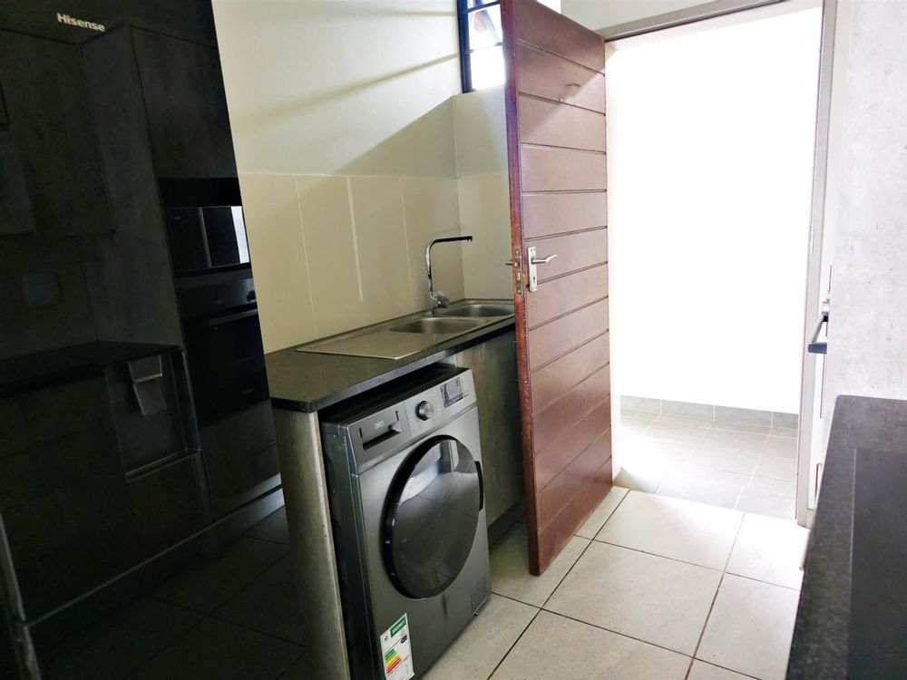 Washing up area and fridge section of kitchen