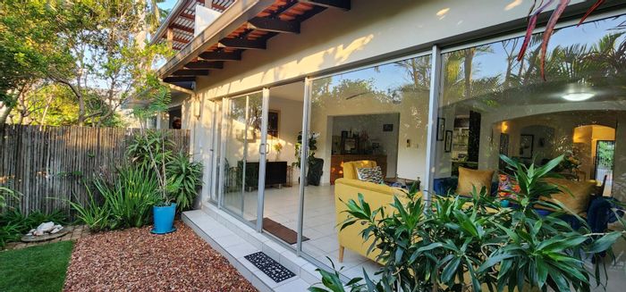 Umhlanga Central Townhouse To Rent: Beach access, pool, spacious living, garden.