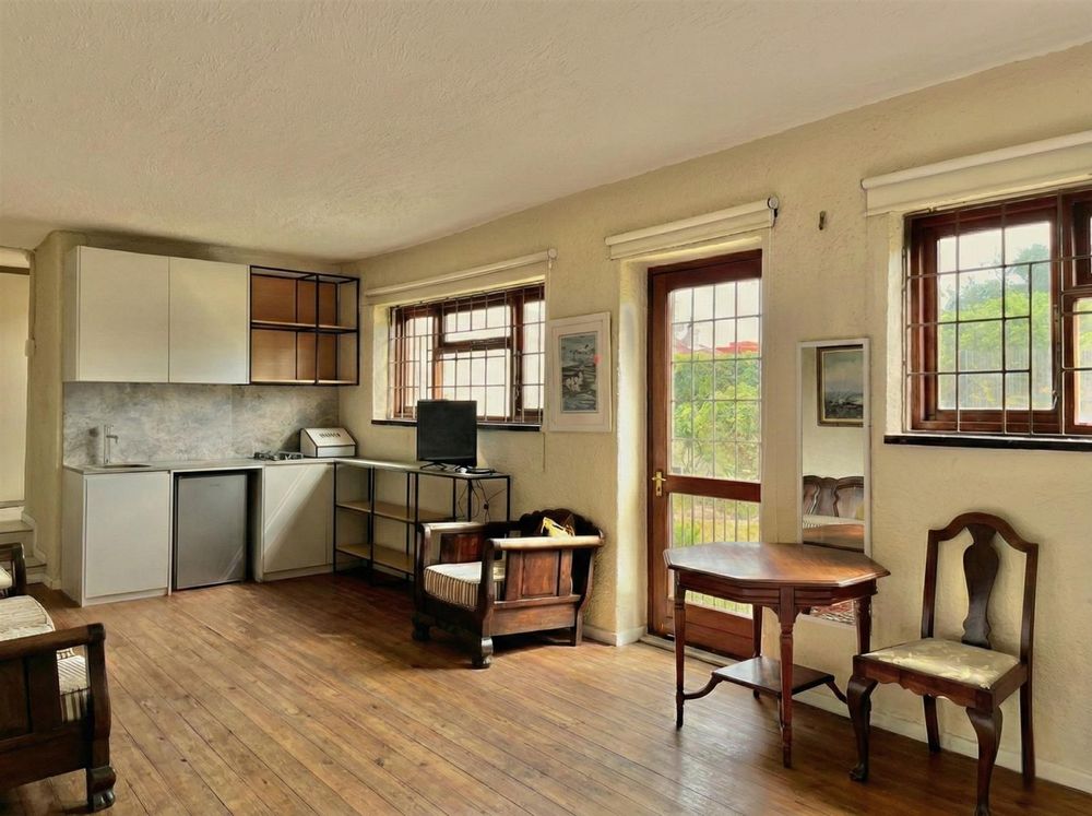 Living area with kitchen and door to garden