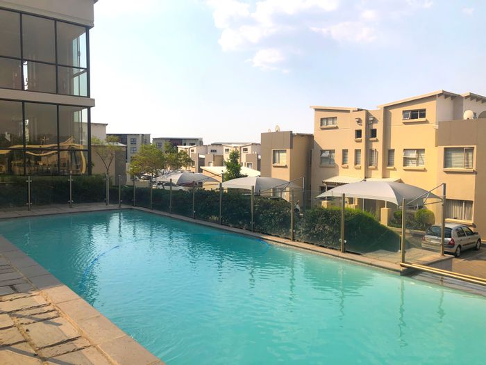 Fourways Apartment To Rent: Two bedrooms, gym, pool, clubhouse, and balcony views.