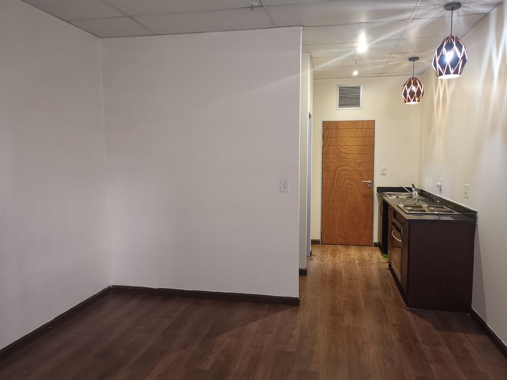 Small kitchen area flowing into the living area