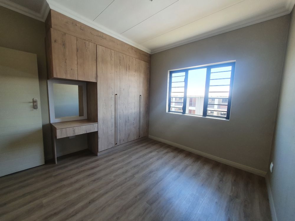 Master bedroom with built-in cupboards.