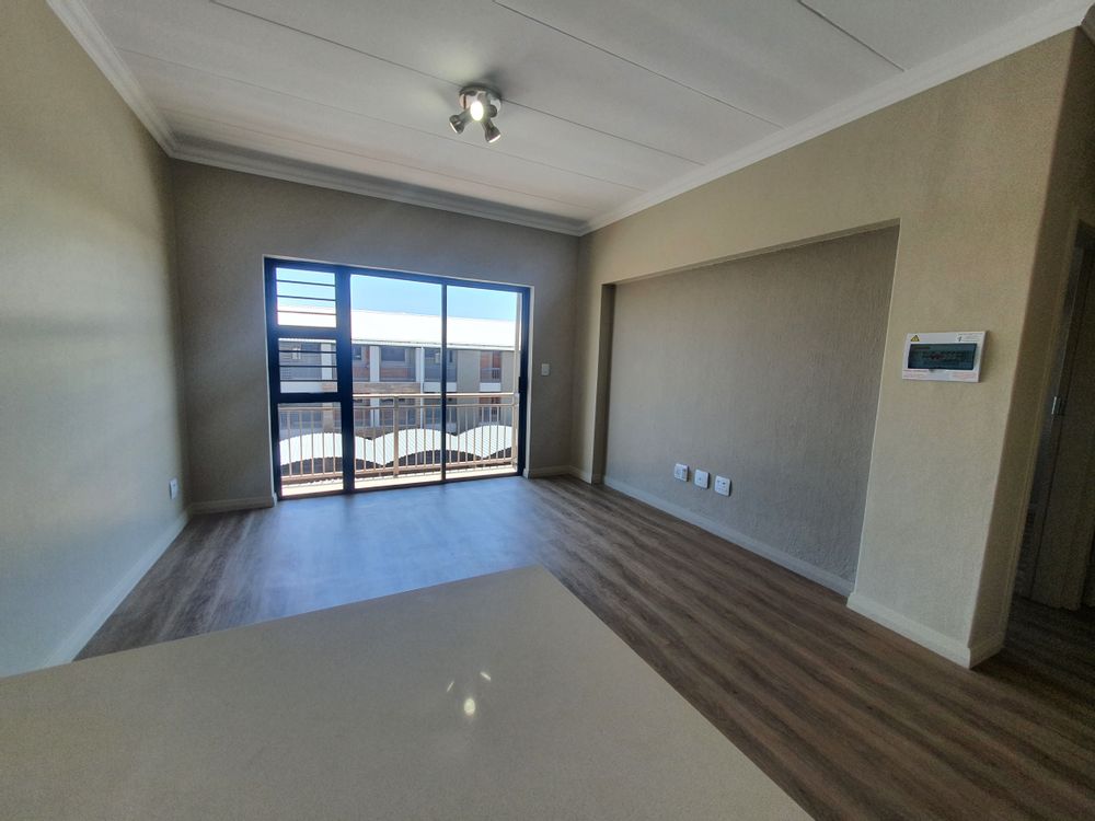 Open plan living space leading onto a small balcony.