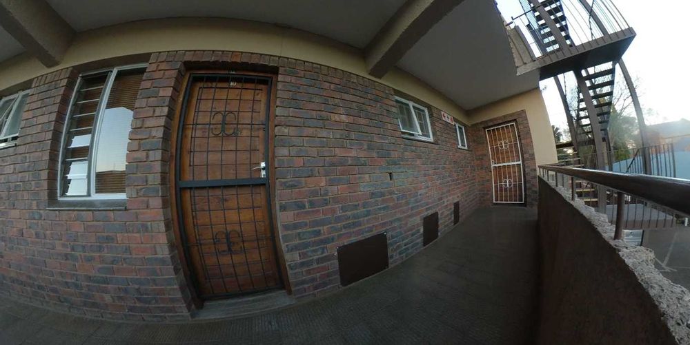 Entrance next to stairs, with large garage underneath with power.