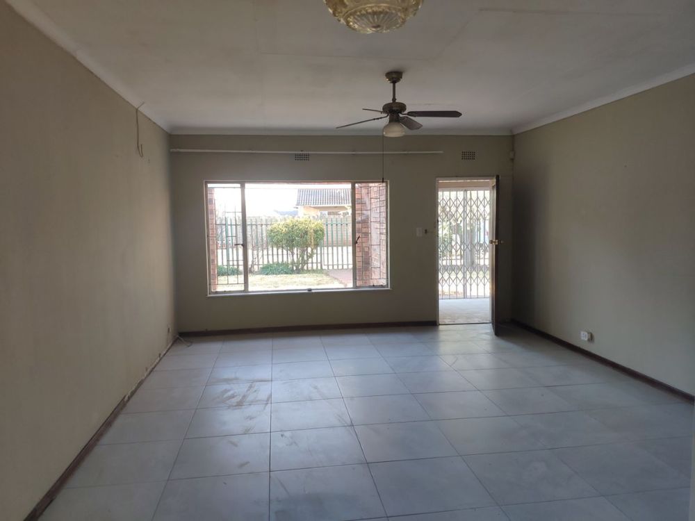 Living room looking out onto Patio (left) and sunroom (front) overlooking front yard