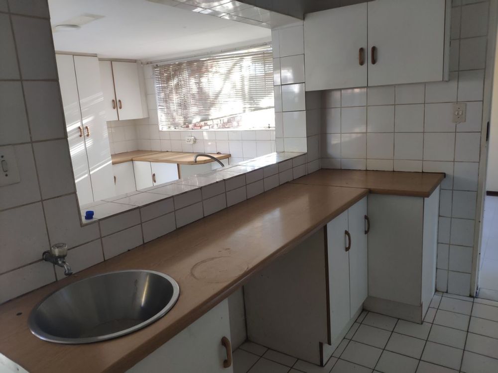 Kitchen looking into Scullery connected to garage