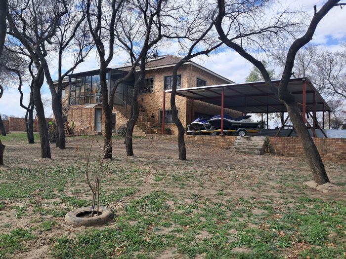 Riverfront farm in Orkney Central for sale, includes solar system and flatlet.