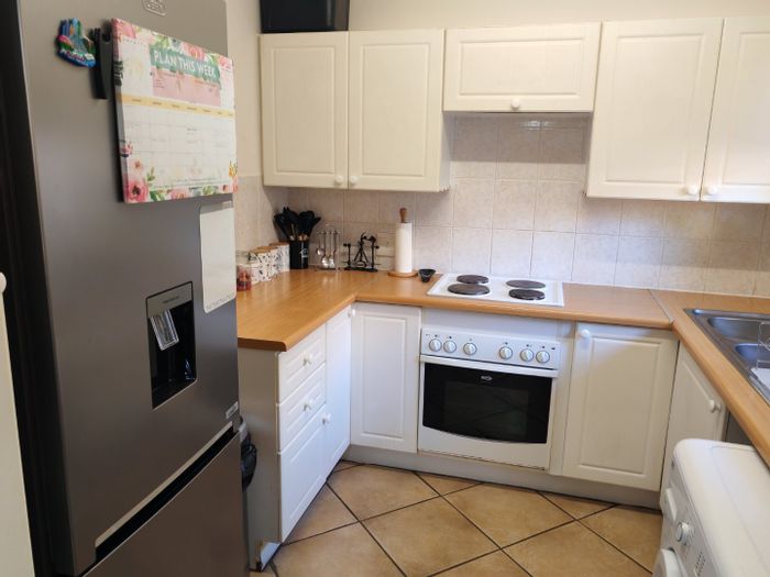 Townhouse For Sale in Rooihuiskraal North: Pool, braai area, 2 bedrooms, garage.