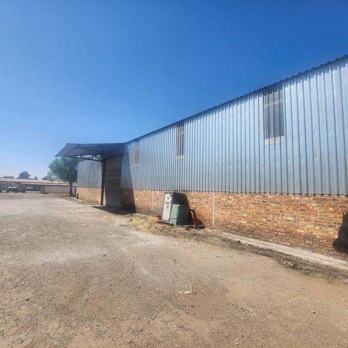 Industrial Property For Sale in Stilfontein Central: Expansive warehouse, offices, and parking.
