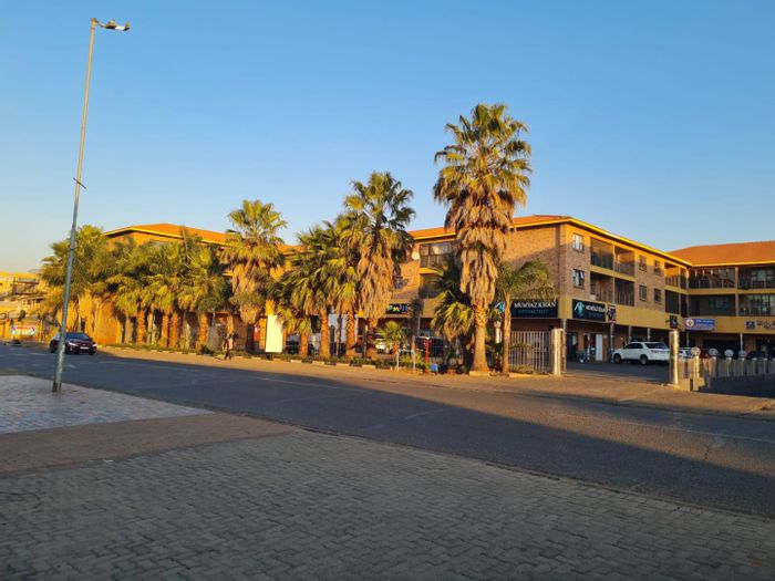 Lenasia Ext 1 Apartment To Rent: Open-plan kitchen, balcony, secure living environment.