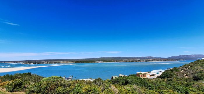Witsand Central House For Sale: Coastal home with river views, guest room, and garden.