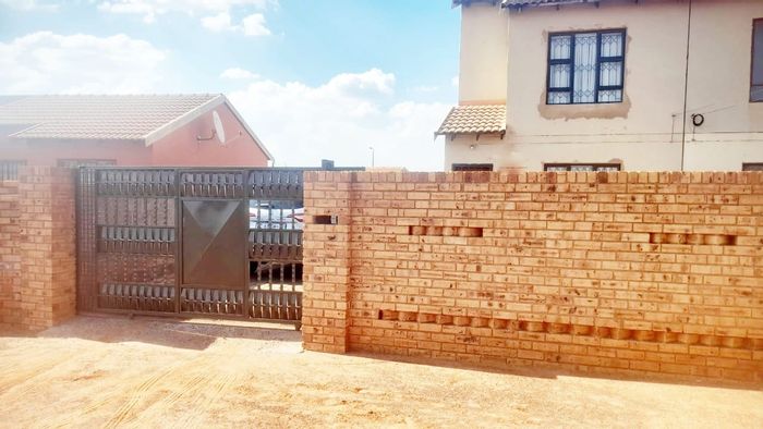 For Sale: House in Bekkersdal with open-plan layout, spacious yard, and secure access.