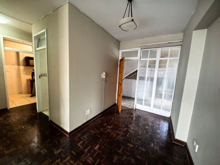 North Beach Apartment For Sale: Spacious lounge, enclosed balcony, modern kitchen.