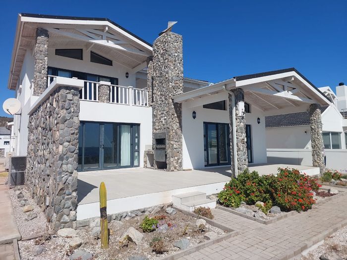Beachfront house in Sandy Point Beach Estate, 4 beds, direct beach access, for sale.