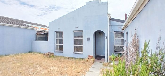 For Sale: Four-bedroom house in Strandfontein Village with garage and paved backyard.