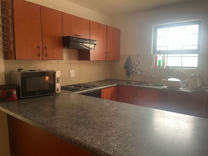 For Sale: Townhouse in Jansenpark with pool, two bedrooms, and carports.