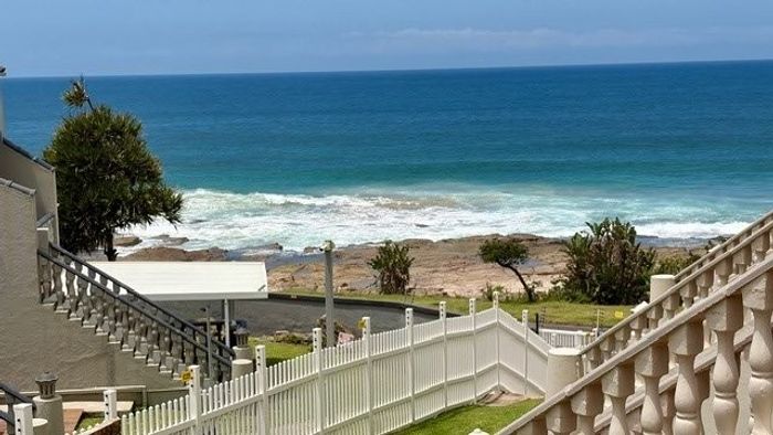 Beachfront townhouse in Uvongo for sale, featuring ocean views and direct beach access.