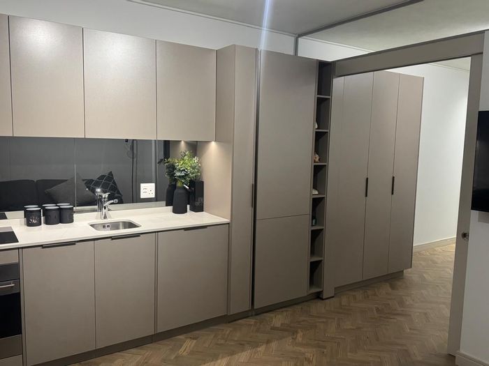 1-Bedroom Apartment To Rent in Rosebank with furnished interiors and equipped kitchen.