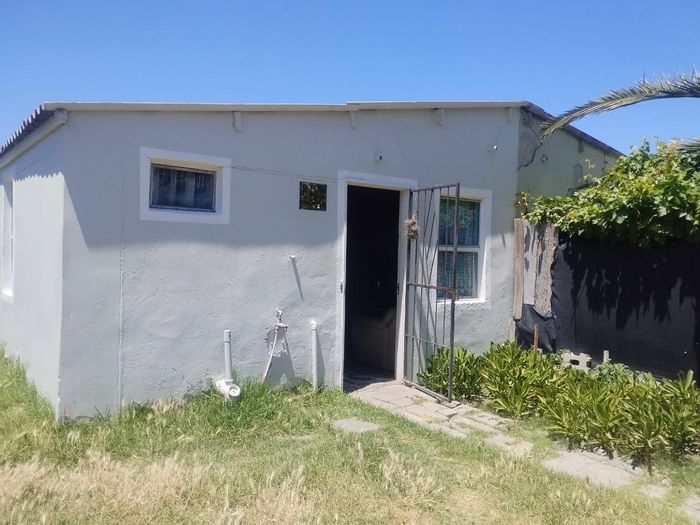 For Sale: House in New Macassar Village with potential, yard, and convenient access.