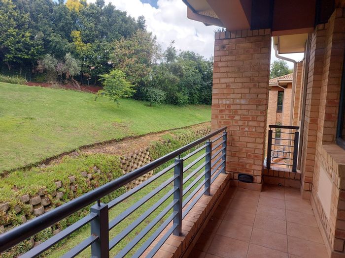 Bryanston Commercial Office To Rent: Spacious suite with balconies, boardroom, and coffee shop.
