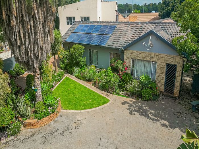 Versatile Rooihuiskraal North house for sale with pool, flatlets, and solar system.