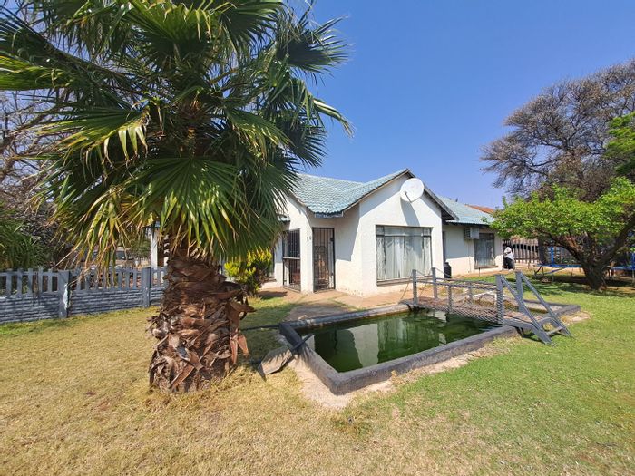 For Sale: Spacious 4-Bedroom House in Stilfontein Central with Borehole and Double Garage.