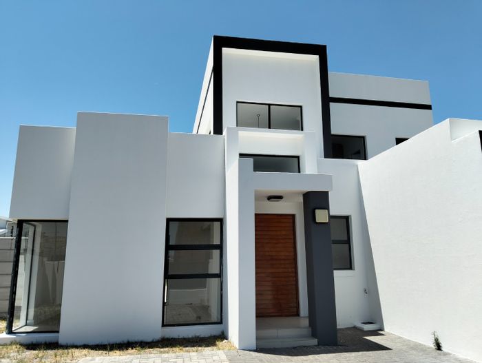 For Sale: House in Parklands North with double garage, garden, and built-in braai.